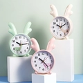 Minimalist cartoon deer alarm clock in pastel green, light pink, and beige variants - Reindeer Antler Style