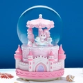 Pink carousel crystal ball featuring a cartoon rabbit on a unicorn with castle base - Automatic Snowfall + Music + Light / Castle Carousel-Pink