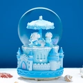 Blue carousel snow globe music box with castle base and white character on a beach - Automatic Snowfall + Music + Light / Castle Carousel-Blue
