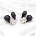 Detail of flower ear clips with black spheres and heart-shaped crystals on white silk - 14k Gold Zx403