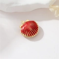 Nahaufnahme von muschelförmigem 14k Goldanhänger mit roter Emaille und radialen Streifen - Granatrot