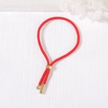 Adjustable red woven cord bracelet with gold metal sliding clasp and polished tips - Red