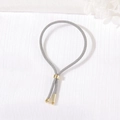 Adjustable grey hand-woven bracelet with polished gold metal sliders and spherical ends - Gray