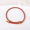Adjustable red braided rope bracelet featuring polished golden cylinder metallic accents - 3mm Rope Thickness / Red