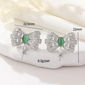 Silver bow earrings with green opal and cubic zirconia charms on white stone base - Palladium Cat Eye Stone Bow Style (WX21895)