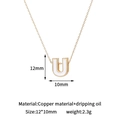 Detail view of gold letter U pendant with white enamel inlay, measuring 12x10mm - U-Single Pendant