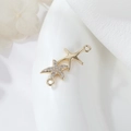 Macro shot of gold-plated starfish connectors with micro-pave cubic zirconia for DIY jewelry - Double Starfish Shape (H-10081)