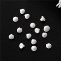 Detailed macro view of 15 pieces of white silicone disk earring backs on black leather - White Bullet Style (D1682)