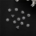 Detailed view of transparent silicone disc earring backs on premium black leather surface - Transparent Disc Style (D1684)
