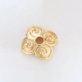 Macro detail of 14k gold-plated flower spacer bead with spiral texture and center hole - Frosted Spiral Four-Petal Spacer (H-8462/8MM)