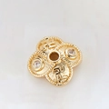 Macro shot of 14k gold plated hollow flower spacer bead with zircon and religious symbols - Swastika Pattern Zirconia Four-Petal Bead (H-8451/7MM)