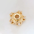 Macro shot of gold-plated 5-petal flower spacer bead with white cubic zirconia accents - Scroll Pattern Rhinestone Five-Petal Bead Cap (H-8455/9MM)