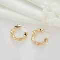 Macro shot of gold C-shaped hoop earrings with wavy geometric texture on white fabric - Stereo Twisted Wavy C-Shape Style (H-7403)