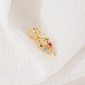 Ethnic style gold pendant with turquoise and red beads on textured white fabric - Ethnic Vajra Style (D1321)