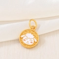 Macro shot of a gold Chinese zodiac sheep charm with white enamel on white silk fabric - D1461 (Goat - Enamel)