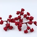 Close-up of artificial red berries decorative stem with detailed foam texture on white back - Triple-fork Red