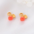 Detail of red bead persimmon charm with gold heart cloud pattern on white fabric - Red Round Bead Pendant with Auspicious Heart Pattern (D1340 Heart)