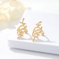Elegant 14k gold plated leaf ear cuffs with botanical veins on a minimalist display - Gold