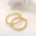 Macro shot of 14k gold circular jewelry connectors with micro-pave white zircon stones - Round Small Pendant (D149) / Gold