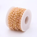 Close-up of 3mm pink faceted crystal beads on golden chain DIY jewelry material - Pink