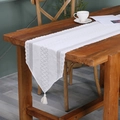 Elegant white lace table runner with hollow geometric patterns and tassel accents - 33x228cm / Zip-line Pointed Table Runner / White
