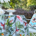 Tropical rainforest print tablecloth in light blue featuring parrots and monstera leaves - Sky Blue Flamingo