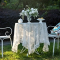 White lace tablecloth featuring intricate hollow patterns and elegant ruffled edges - White Mirror Flower