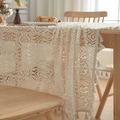 Detailed close-up of retro hollow crochet tablecloth with elegant fringe tassel edges - Beige Lace Grid Long Tablecloth