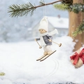 Cute wooden skiing doll Christmas ornament hanging on a snowy pine tree branch - White Hat & Grey Clothes Skiing Doll