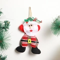 Close-up of handmade fabric Santa ornament with knitted textures and pine branch decor - Plaid Santa Claus