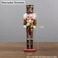 Detail of 30cm wooden nutcracker drummer with red and green uniform on a table - Nutcracker Drummer