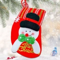 Detail der roten Weihnachtssocke mit Schneemann-Design und goldenem Merry Christmas-Schriftzug - Schneemann