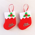 Macro view of small red Christmas stockings with gold Merry Christmas text and white trim - Red