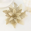 Macro shot of gold artificial Christmas flower head with glitter and satin petal details - Pentagon Pine Leaf Gold