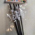 Set of 4 Halloween skeleton straws with black tubes and white skulls in packaging - A Skeleton Style