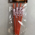 Set of 4 orange Halloween party straws featuring white 3D skull ornaments and retail pack - B Skeleton Style