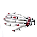 Detail of white skeleton hand hair clip with red nails and realistic bone joints - Blood White