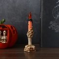 Candela elettronica mano di scheletro Halloween con fiamma arancione e base di teschi - Grande / Arancione