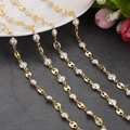Detail view of 18K gold-plated pig nose chain links and white pearls on a stone surface - 1m / U-Link Pig Nose Shape Pearl Chain (6)
