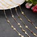 Detail of 14K gold-plated necklace with textured star and moon charms on dark stone - 1m / Star Moon Pendant Fine Chain (3)