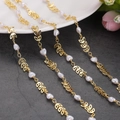 Detail of gold leaf metal links and heart pearl charms on DIY necklace chains - 1m / Hollow Leaf Heart Decoration Chain (2)