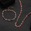 Golden evil eye jewelry set with red enamel necklace and bracelet on black background - Red Evil Eye Necklace and Bracelet Set (3)