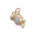 Macro shot of candy-shaped golden copper pendant with pink and blue glittery hearts - Heart Embellished Candy Style