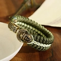 Detail of army green paracord bracelet with antique bronze Spartan skull buckle on wood - Spartan Skull Bronze Clasp Army Green Beige Rope (ABL163-1)