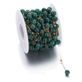 DIY jewelry chain with dark green round beads and golden beads on a white spool - Dark Green