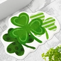 Detail view of the soft clover-shaped bath mat texture on a modern gray tile floor - St. Patrick's Day-12