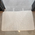 Creamy white pebble-embossed coral fleece bath mat with non-slip texture for bathroom - White