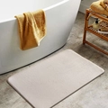 Detail of cream memory foam bath mat with soft texture on grey stone floor decor - Camel / 40*60cm