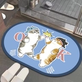 Detail view of oval diatomite mat with cartoon cats on light blue bathroom floor - Oval Cat Pattern 9
