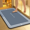 Detail showing the absorbent diatom mud bath mat with Enjoy Every Day text and non-slip texture - Soft Blue